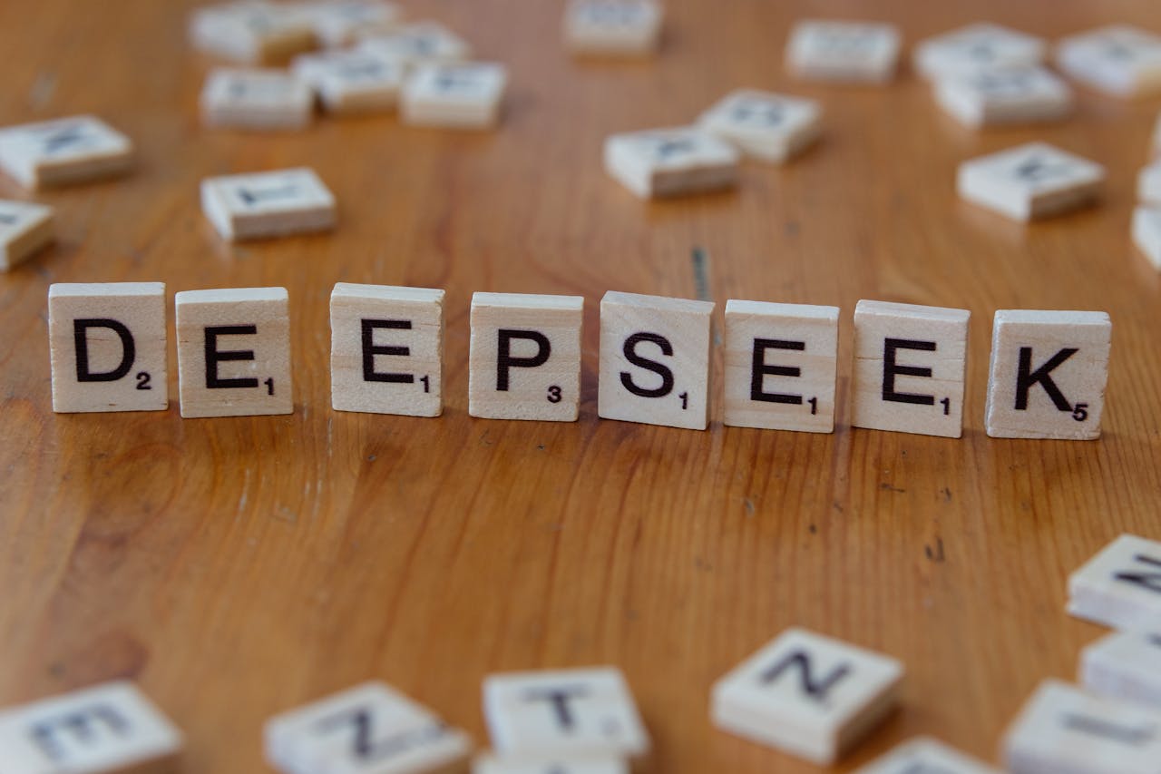 Scrabble tiles spelling DeepSeek on a wooden surface. Perfect for AI and tech themes.